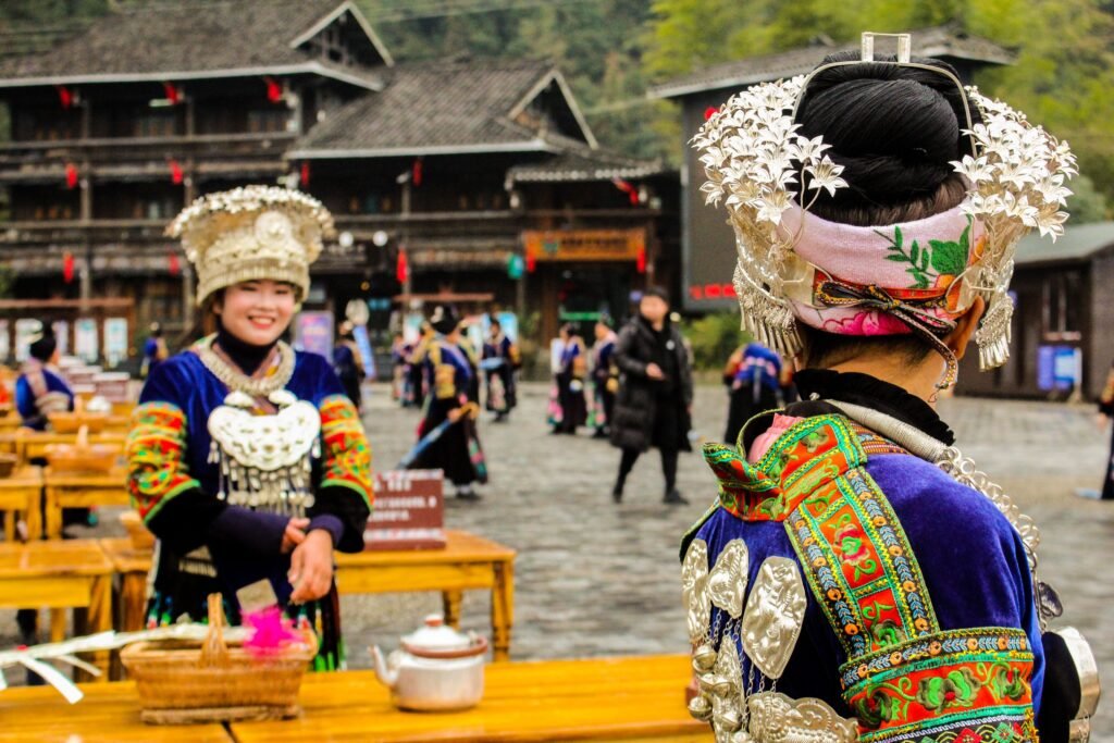 Miao women in traditional attire in Xijiang Qianhu Miao Village, Guizhou, China.