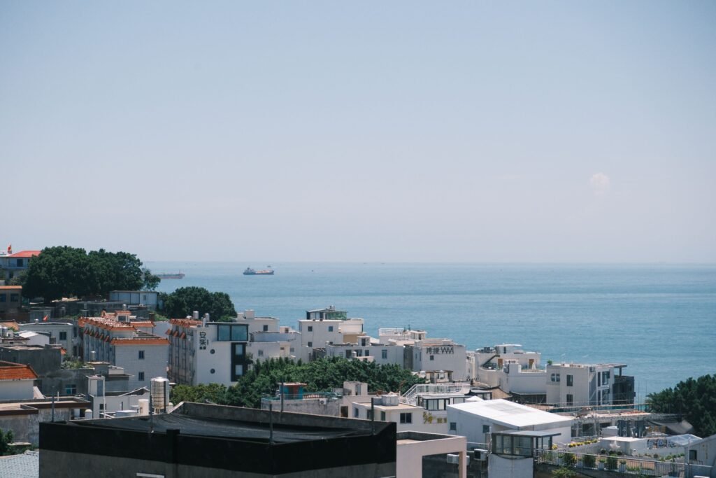 Beautiful coastal cityscape overlooking the sea on a clear summer day, perfect for travel inspiration.
